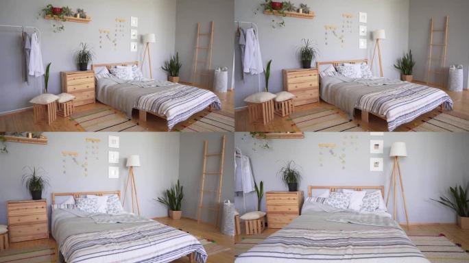 卧室套装，配有斯堪的纳维亚风格的舒适配饰。一张有大量枕头、柔软地毯和毯子的床。