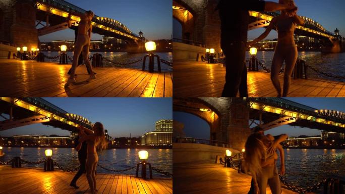一个女人和一个男人晚上热情地跳舞。