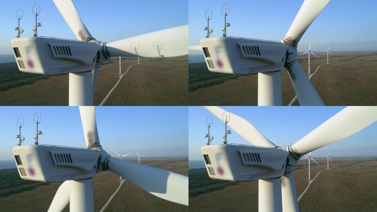 风力涡轮机的特写镜头。空中俯视图风力涡轮机，在白色上方移动的风力涡轮机的现代结构是将风的动能转换为电