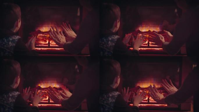 妈妈和儿子在壁炉旁暖手。