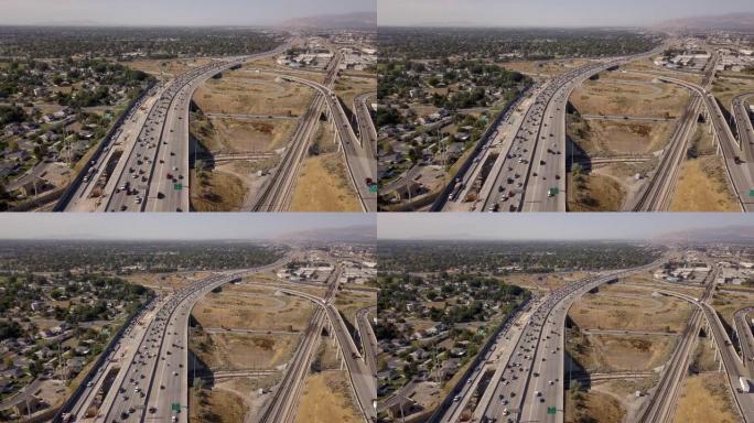 空中无人机剪辑俯视I-15，盐湖城通勤交通和火车的I-80