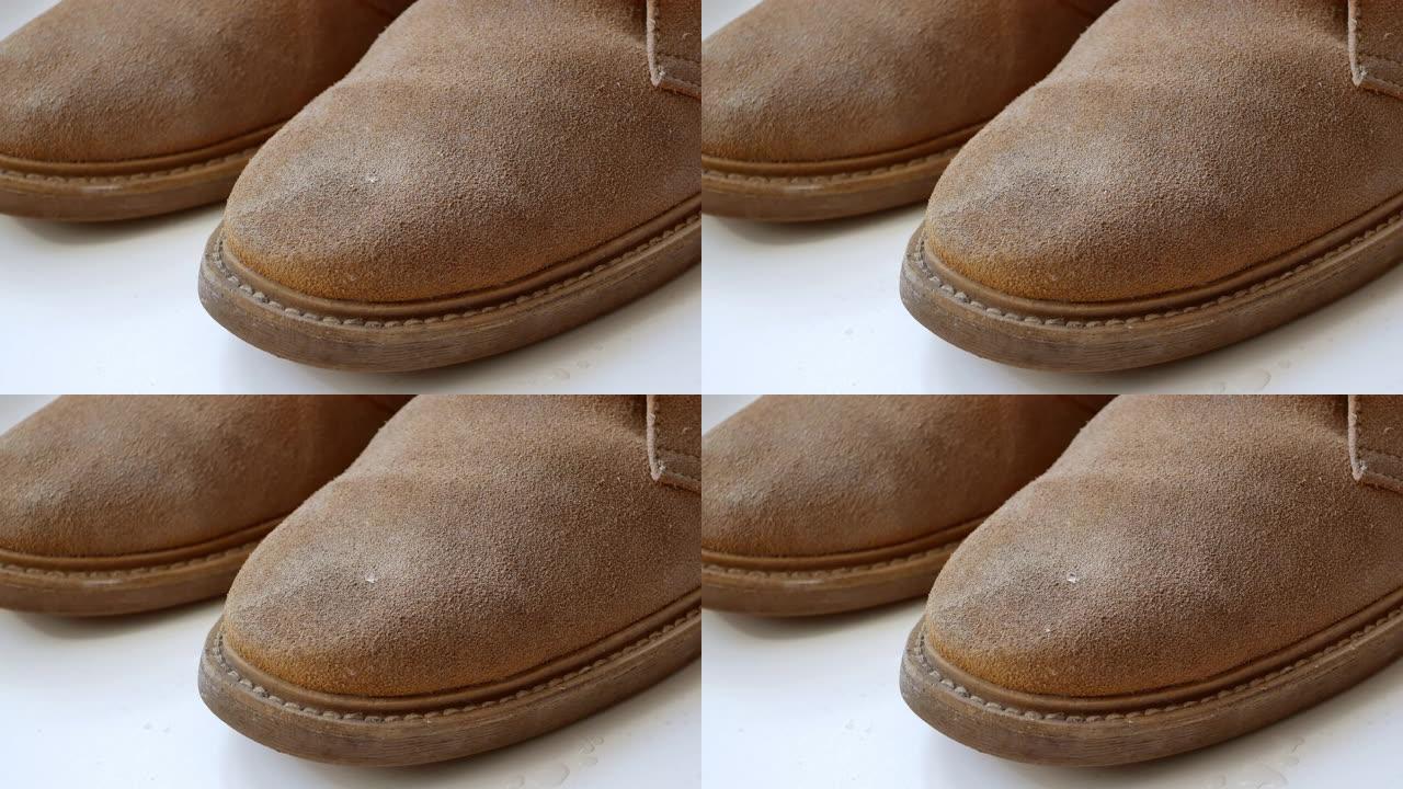 鞋子、靴子的防水涂层示例。水滴落在鞋表面并滑落