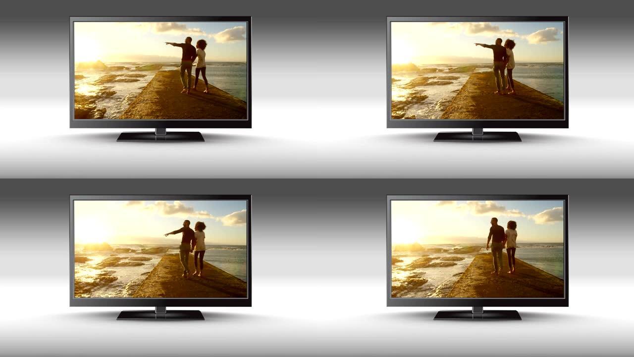 平板电视，屏幕上有一对夫妇在海滩上