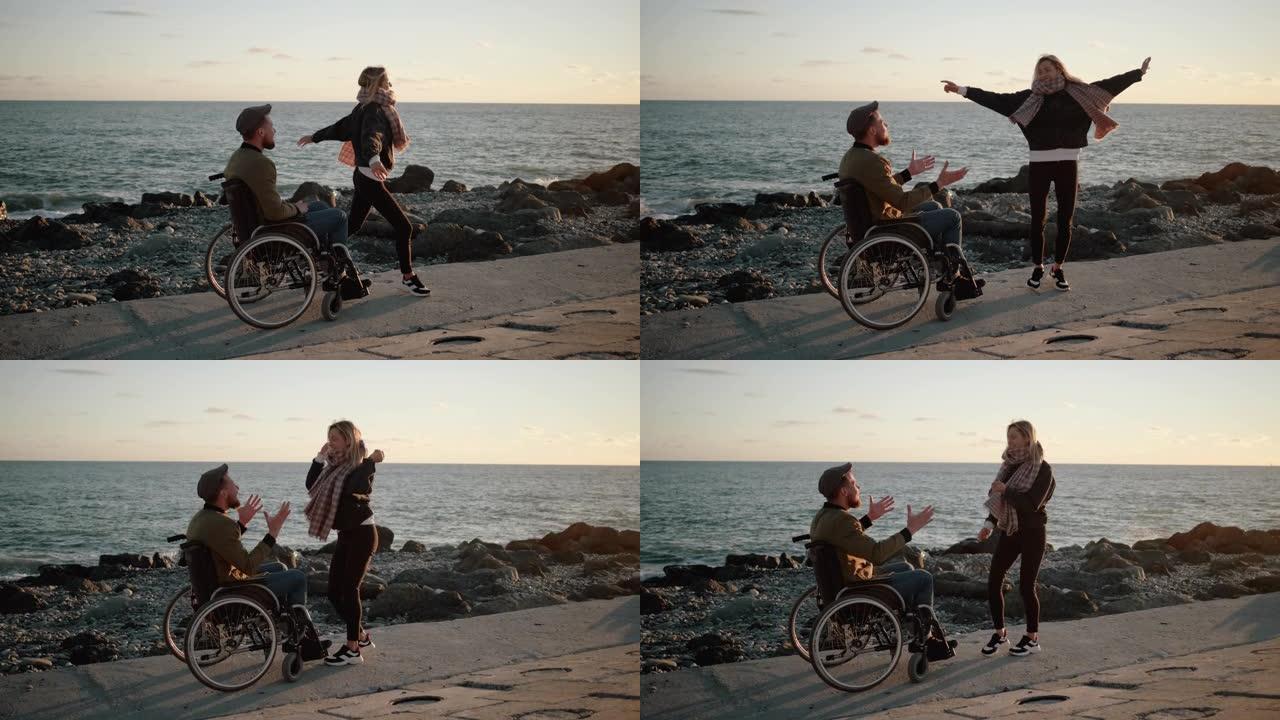 残疾男子和他健康的女友在海边玩耍，跳舞