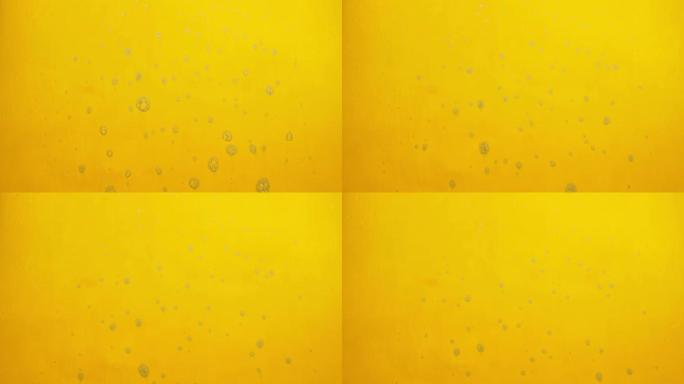 黄色背景上流动的肥皂产生泡沫。