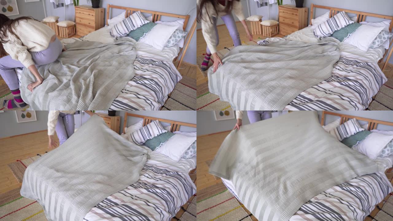 一个穿着家装的女人下床，用灰色格子铺上床。斯堪的纳维亚风格公寓