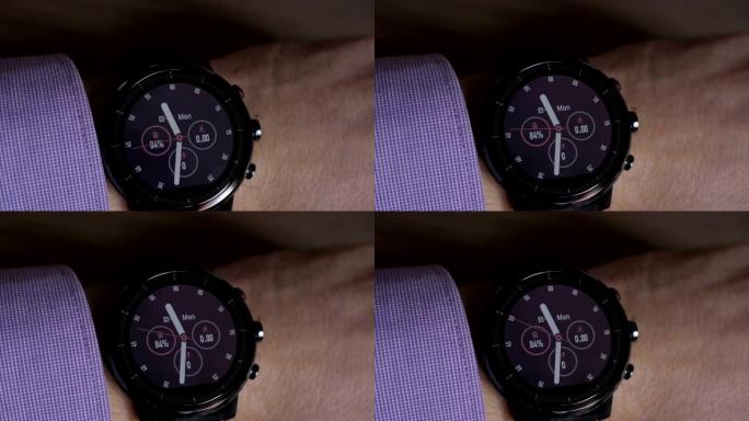 商人在智能手表上检查时间。特写。戴着时尚智能手表的家伙的手。现代小工具，可让您始终保持与intern