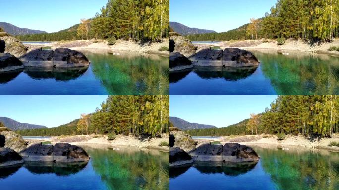 在秋天的好天气下，山翠绿湖的风景。湛蓝的秋天天空。宁静狂野的大自然。稳定的镜头。