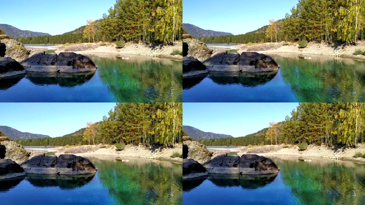 在秋天的好天气下，山翠绿湖的风景。湛蓝的秋天天空。宁静狂野的大自然。稳定的镜头。