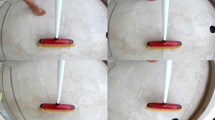 用扫帚扫除瓷砖地板上的灰尘，pov
