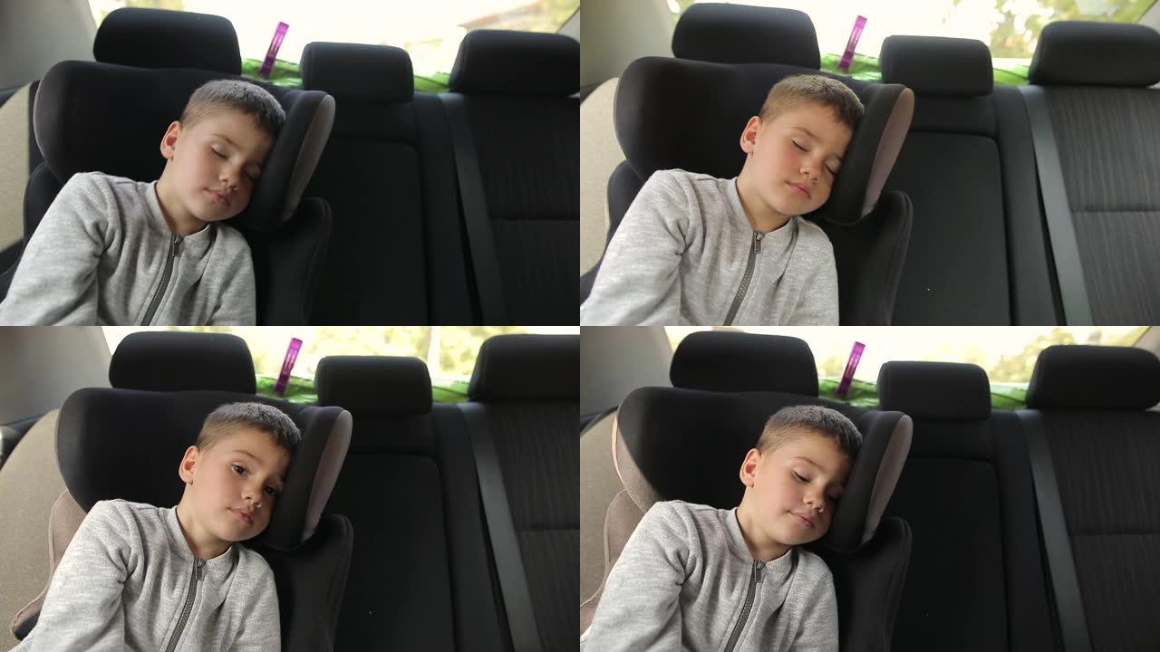 度假期间公路旅行时睡在汽车安全座椅上的疲惫小孩