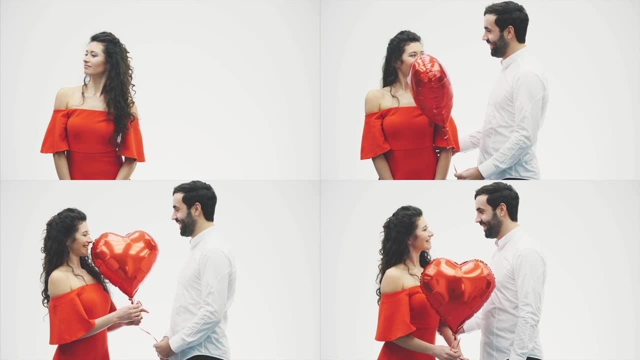 情人节夫妇。美少女和她英俊的男朋友拿着心形气球接吻。幸福快乐的家庭。爱。情人节。