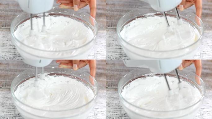 制作蛋白酥皮的阶段: 用糖将蛋清打至光滑坚硬的峰值。