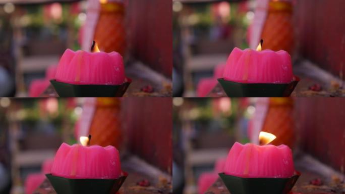 庆祝农历新年期间，道观教堂燃烧的粉红色蜡烛产生的火焰。4k
