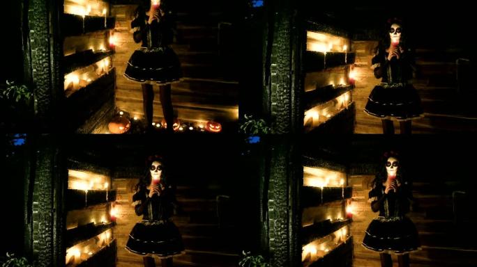带着可怕的骷髅万圣节化妆的年轻女子手持点燃的蜡烛。高清