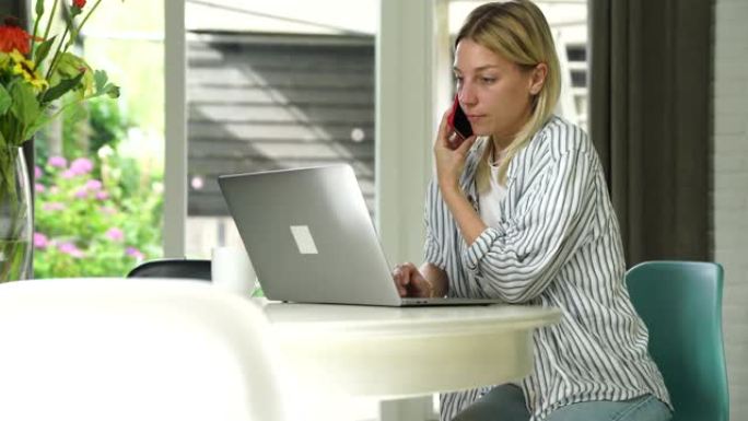 严重的白人女性自由职业者使用笔记本电脑在家庭内部远程工作