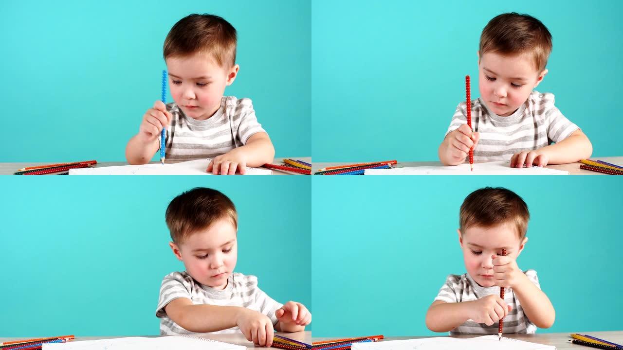 受启发的小男孩在桌子上用铅笔画画，孤立在蓝色上