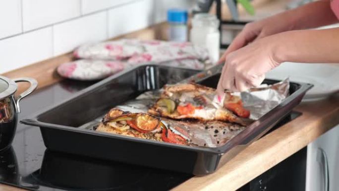 库克切煮熟的鱼，厨师用菜刀切煮熟的鳟鱼的特写镜头。