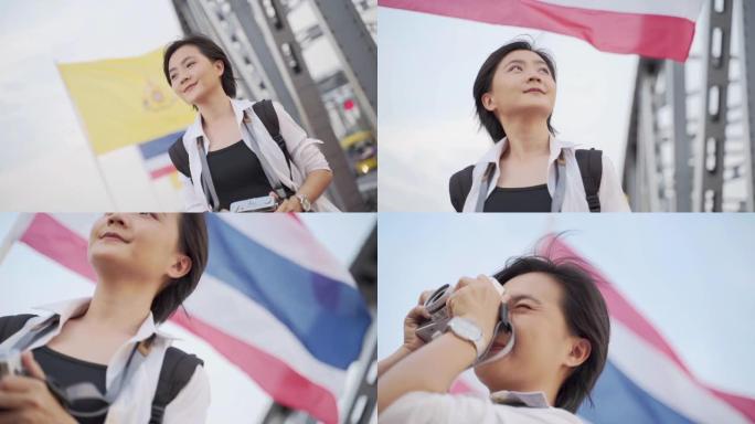 慢镜头:一名亚洲女子在桥上拍照