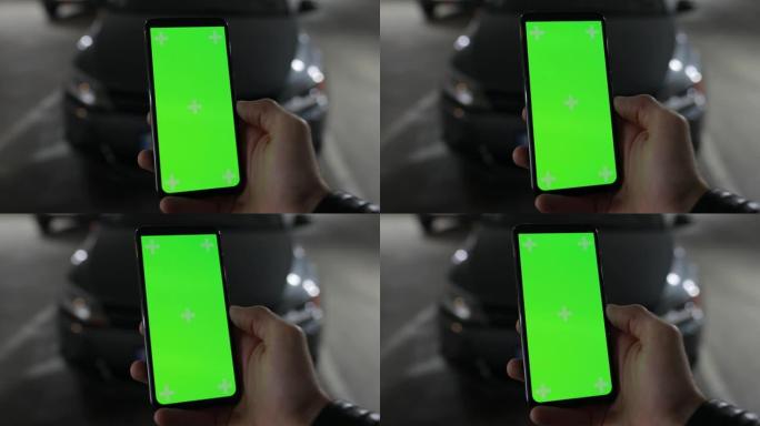 智能手机与汽车相连的男性手持绿屏模型报警