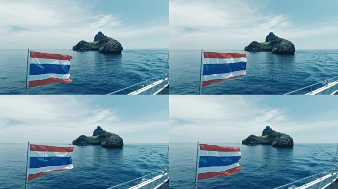 泰国热带岛屿附近船上飘扬的泰国国旗