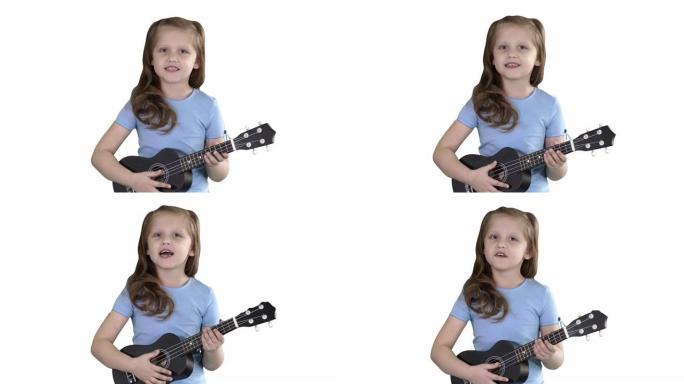 小女孩在白色背景上走向相机时唱歌和弹小吉他