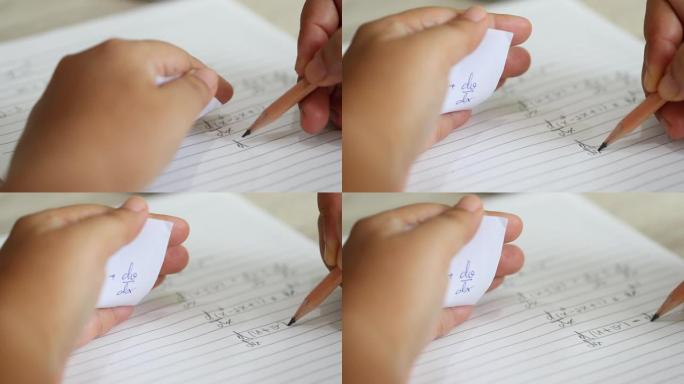 学生使用公式数学表在考试中作弊。大学生手持铅笔在考试中做数学题，在考试中作弊，手拿答案纸。