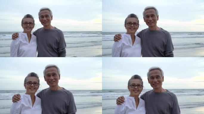 亚洲夫妇老年长镜头特写日落海滩蜜月家庭一起幸福生活方式，慢动作镜头