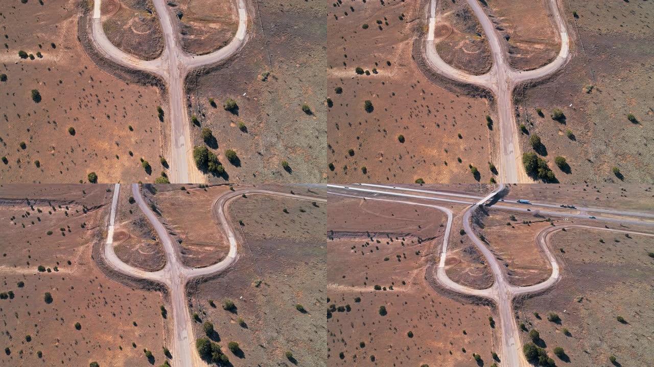 新墨西哥州埃奇伍德附近沙漠中的老肮脏乡间小路。带有倾斜摄像机运动的空中无人机视频
