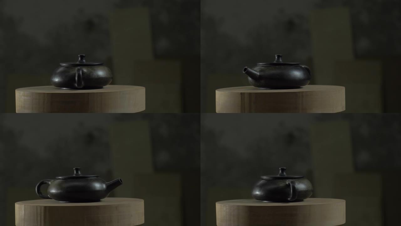 烧制后的黑色宜兴陶罐在木架上旋转。茶道手工制作的粘土茶壶。4k视频。59.94 fps
