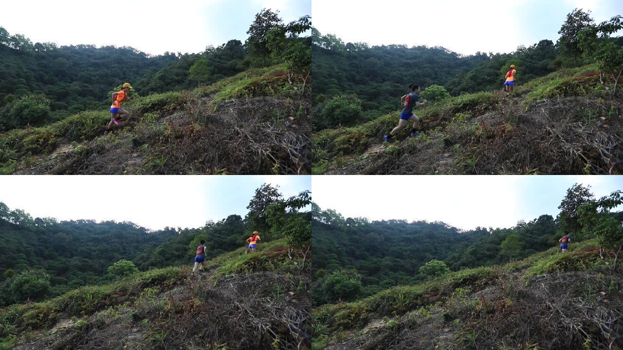 女子越野跑运动员在热带森林的山坡上奔跑