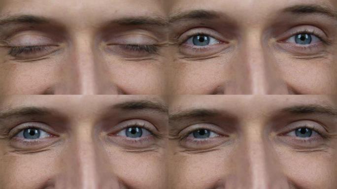 男性眼睛的特写。打开男人看着相机的蓝眼睛的细节。快乐微笑的白人男性清醒地看着
