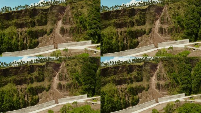 菲律宾卡米金岛上有混凝土围栏的道路。保护道路免受落石和山体滑坡的影响