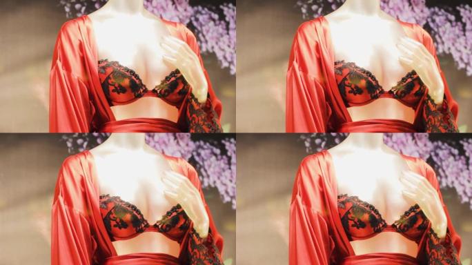 穿着红色丝绸浴袍和内衣的女性人体模型。时尚迷人性感