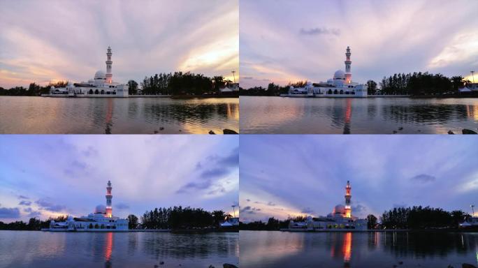 马来西亚浮动清真寺的时间流逝，在令人惊叹的日出背景下反射在湖上。