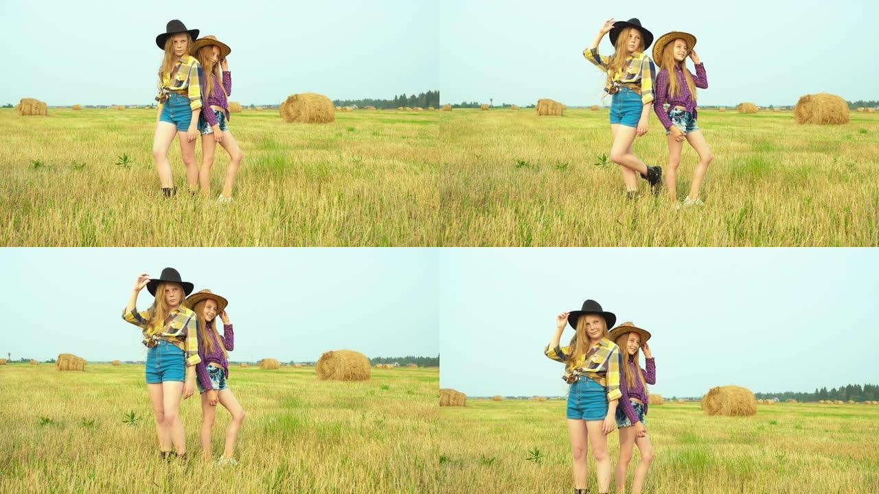 戴着牛仔帽的女孩站在乡下的田野上