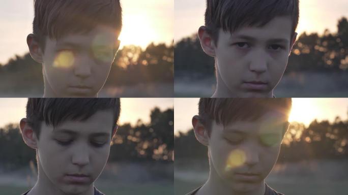 日落时麦田里悲伤男孩的肖像看着镜头特写