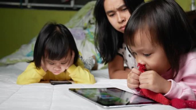 亚洲妈妈骂她的孩子看电话太久，孩子沉迷于电话。