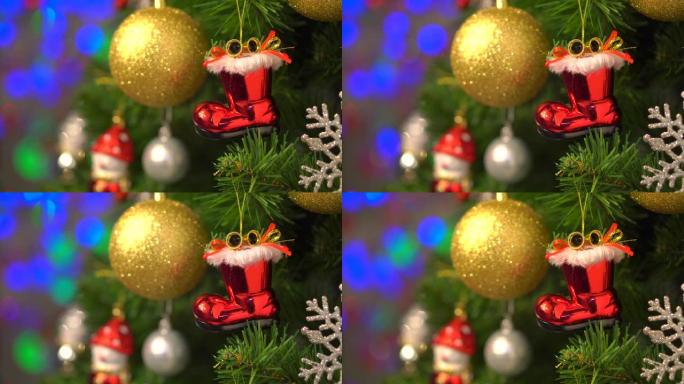 圣诞红色袜子和金球装饰品圣诞树上的装饰品模糊的bokeh灯背景