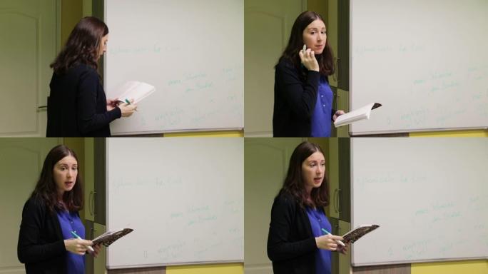 女专业老师在教室白板前向课堂讲解课程