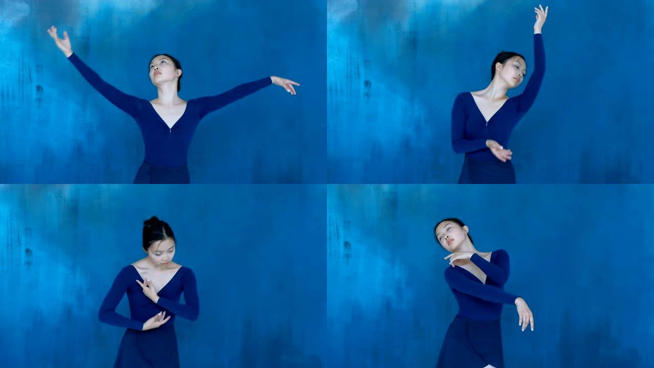 专业芭蕾舞演员在感官上跳舞，双手在蓝色背景上流畅地动作