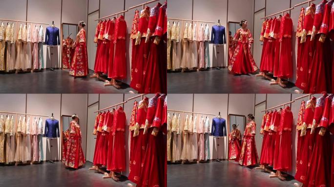 年轻的中国新娘在设计师工作室试穿婚礼群瓜