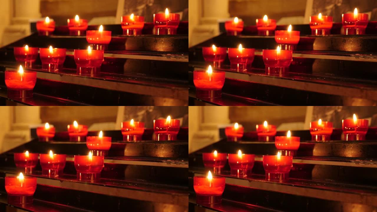 蜡烛架上的许多红色基督教祈祷奉献蜡烛4K