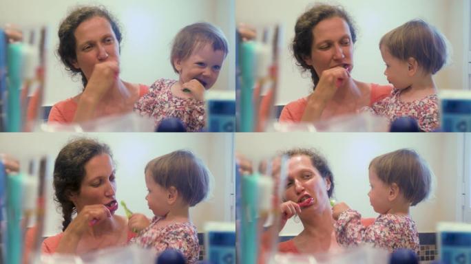 母女俩一起刷牙。特写女孩在浴室和母亲刷牙的肖像。母亲和女儿在浴室刷牙。儿童心理学。儿科