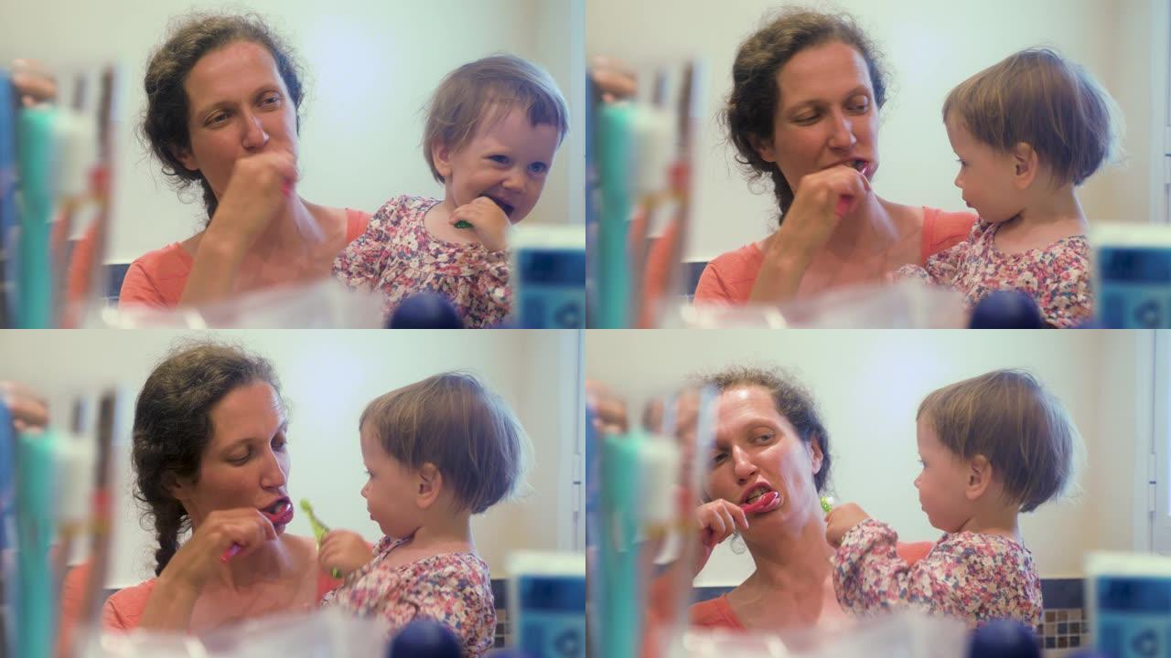 母女俩一起刷牙。特写女孩在浴室和母亲刷牙的肖像。母亲和女儿在浴室刷牙。儿童心理学。儿科