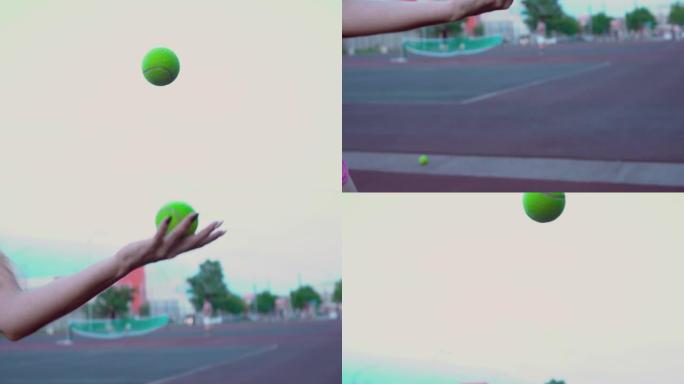 女孩打网球。手姑娘将球抛向空中，然后在训练中接球。