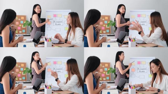 一群美丽快乐的亚洲女性在办公场所开会讨论或集思广益创业项目。赋权女性团队合作的概念。