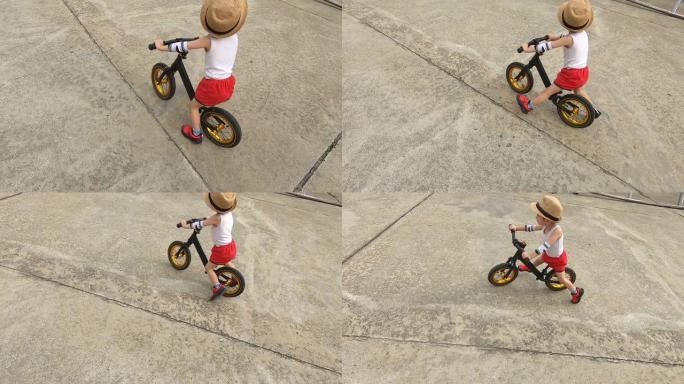 慢动作，可爱的男孩玩平衡自行车