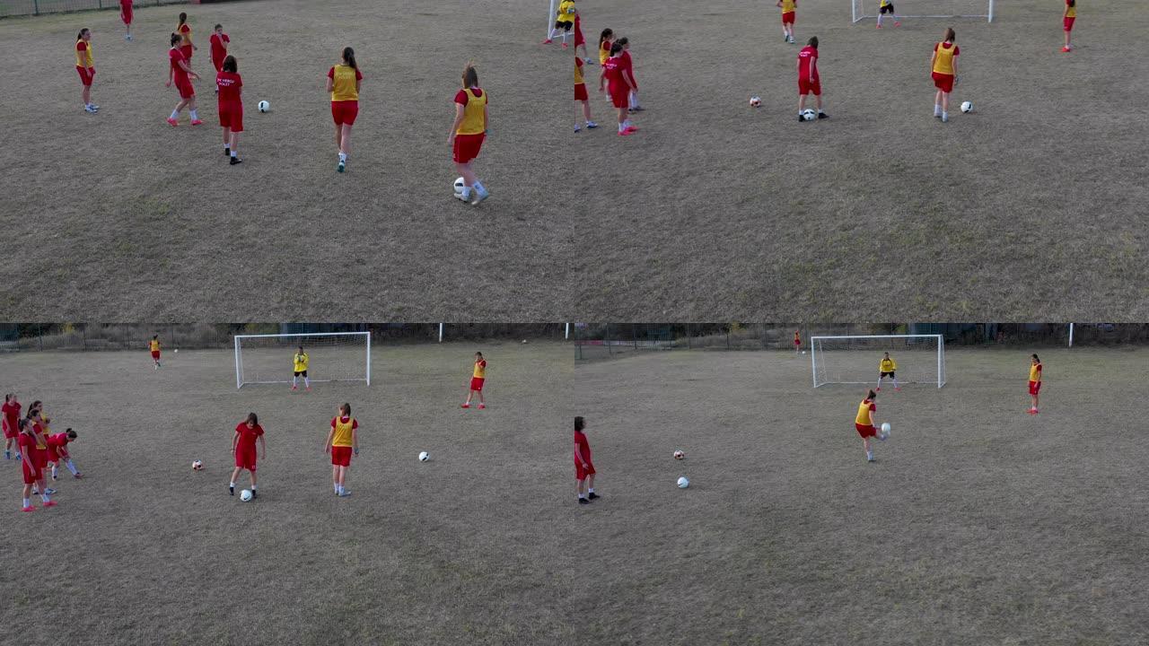 女子足球队在足球场上训练