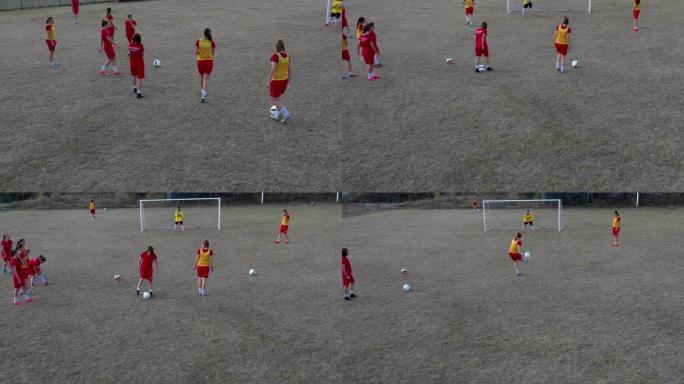 女子足球队在足球场上训练